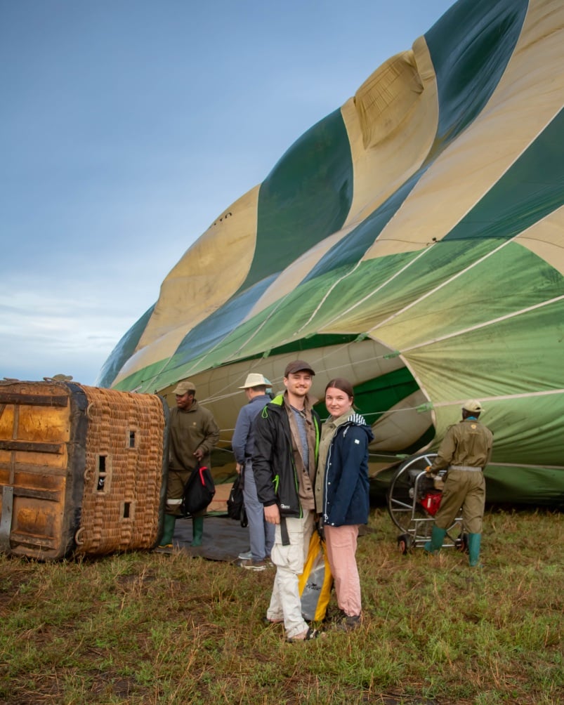 Travellers in front of hot air balloon