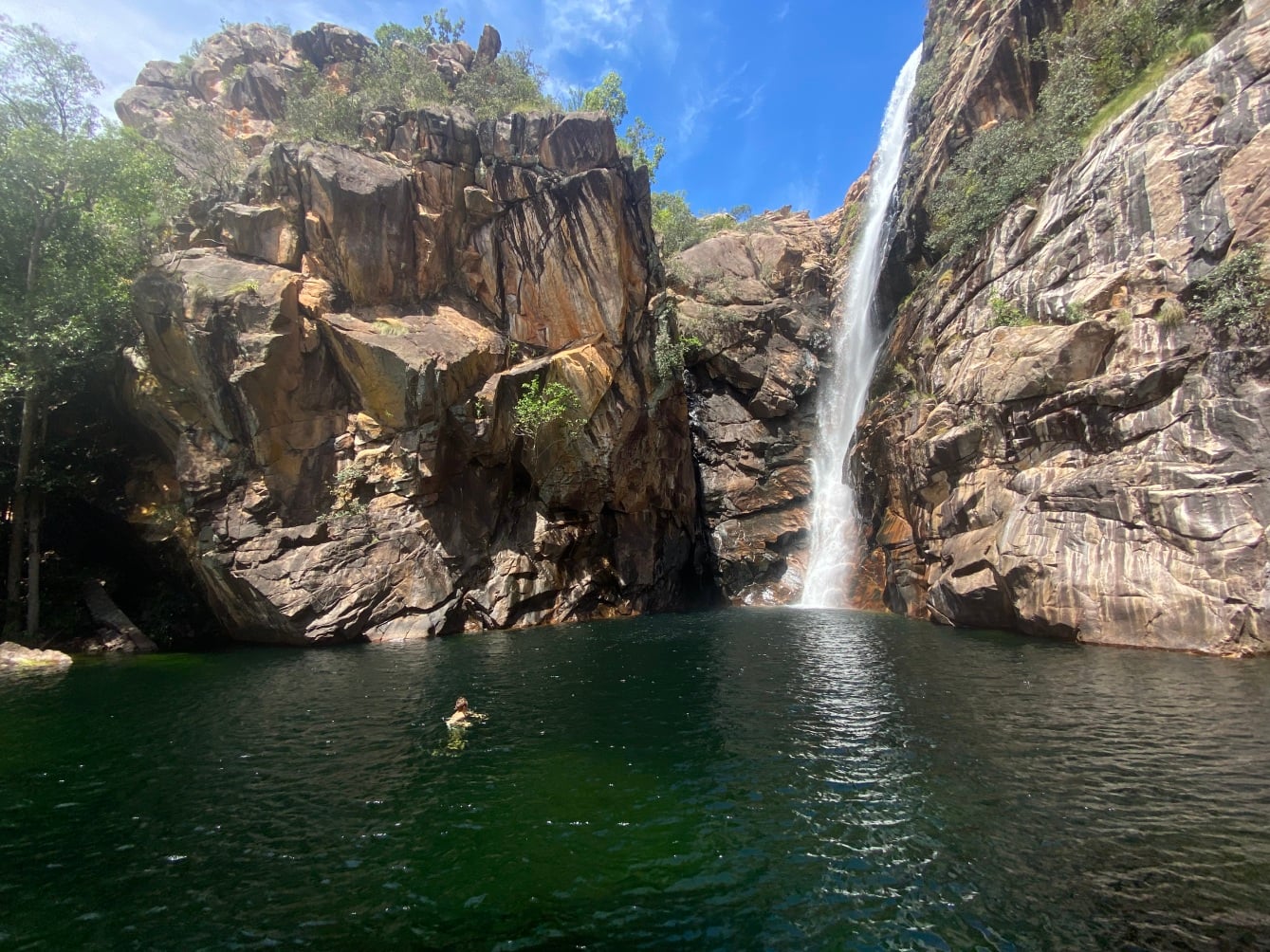 Customer swimming by the waterfall in Kakadu