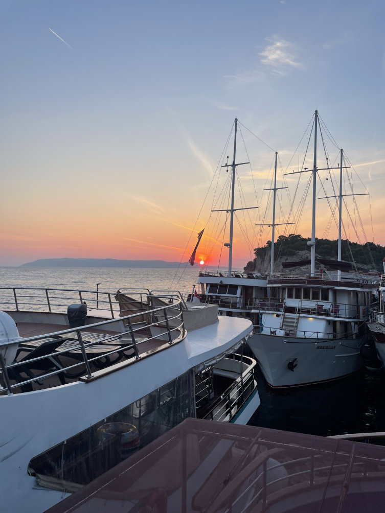 Sunset behind sailing boats