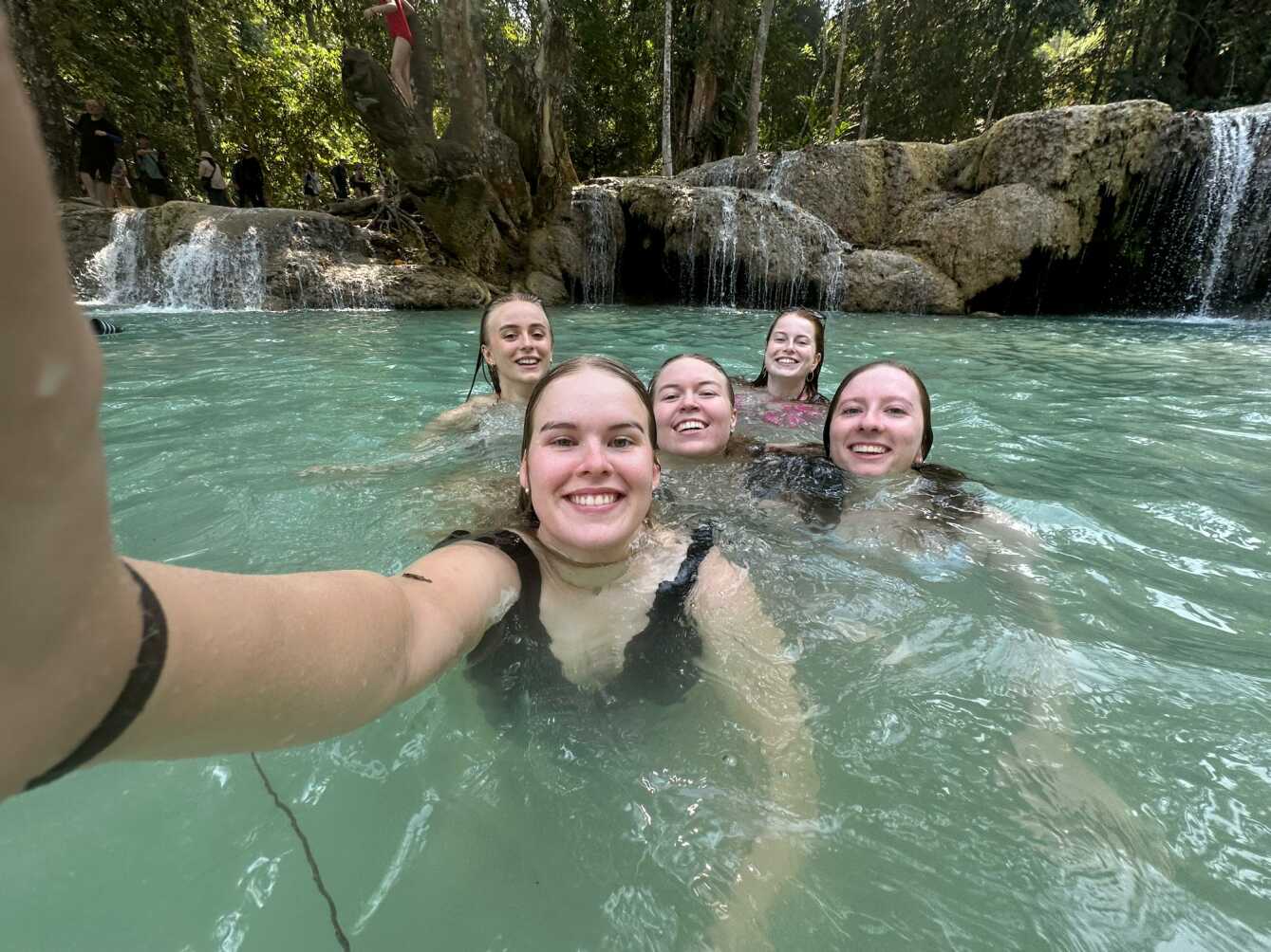 Backpackers taking a selfie while swimming in Vang Vieng