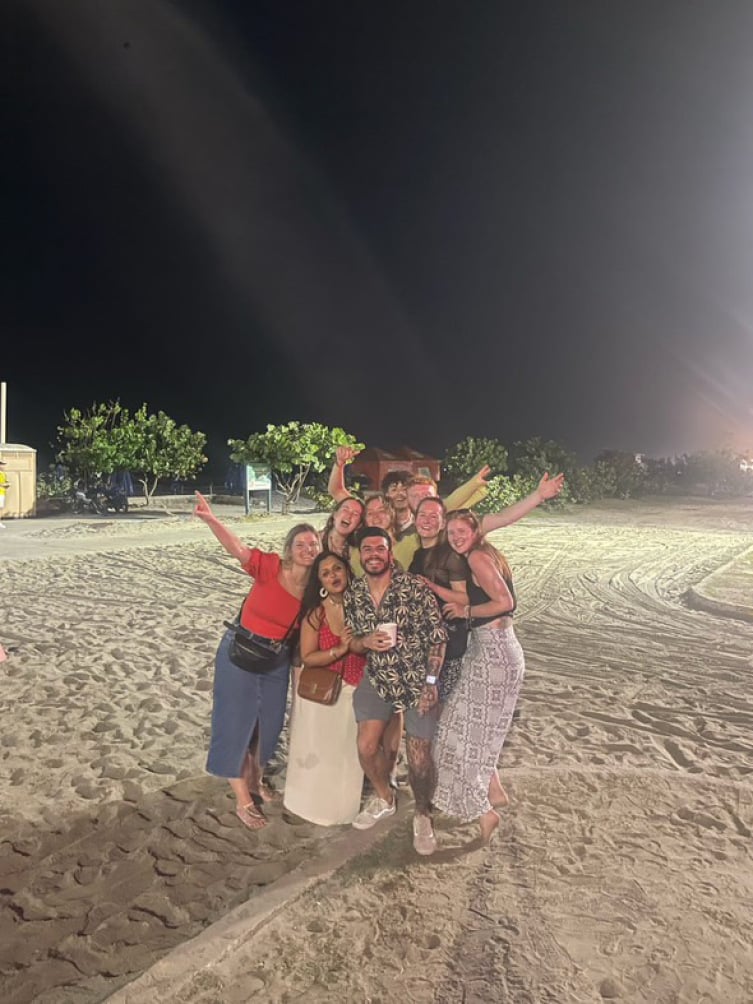 Group of backpackers at the beach together