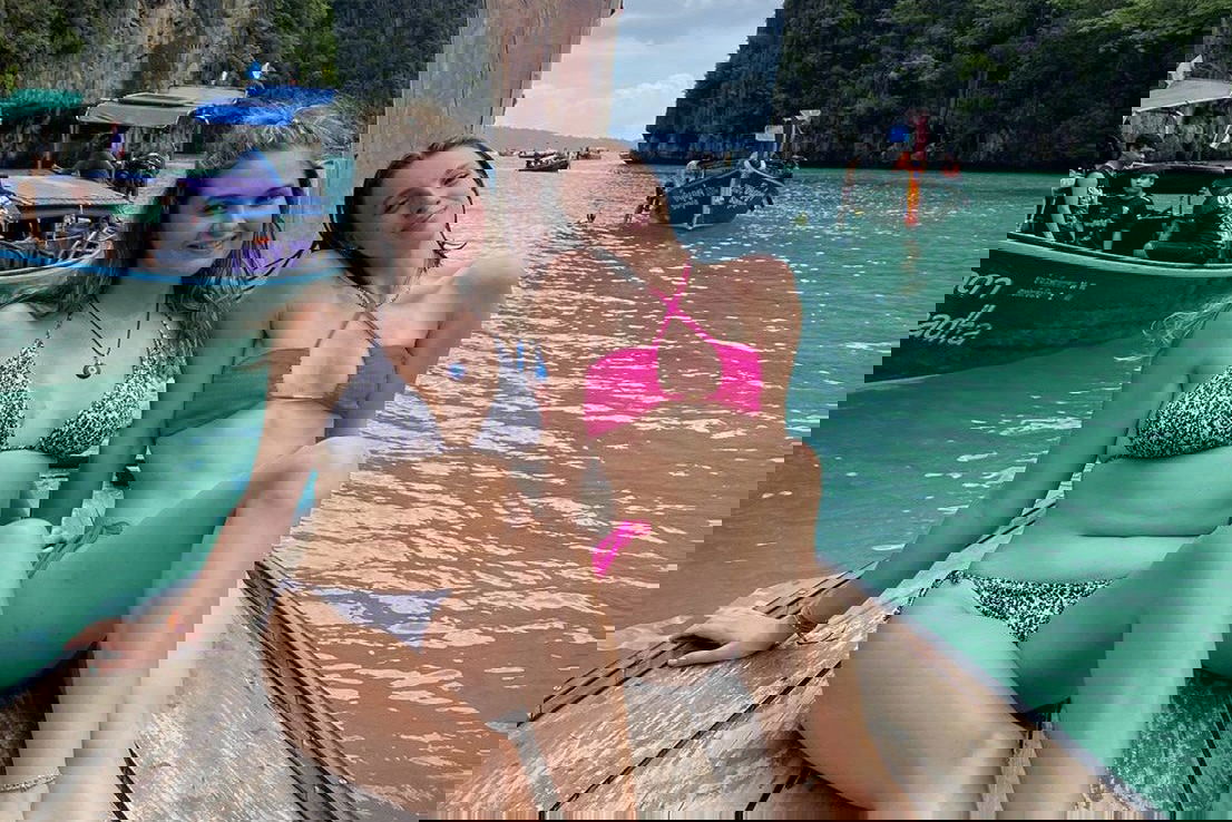 Two girls say on a boat in Maya Bay