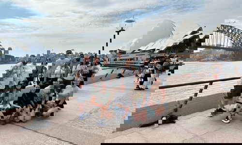 Group of travellers in front of Sydney Harbour in Australia