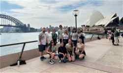 Group of travellers in front of Sydney Harbour in Australia