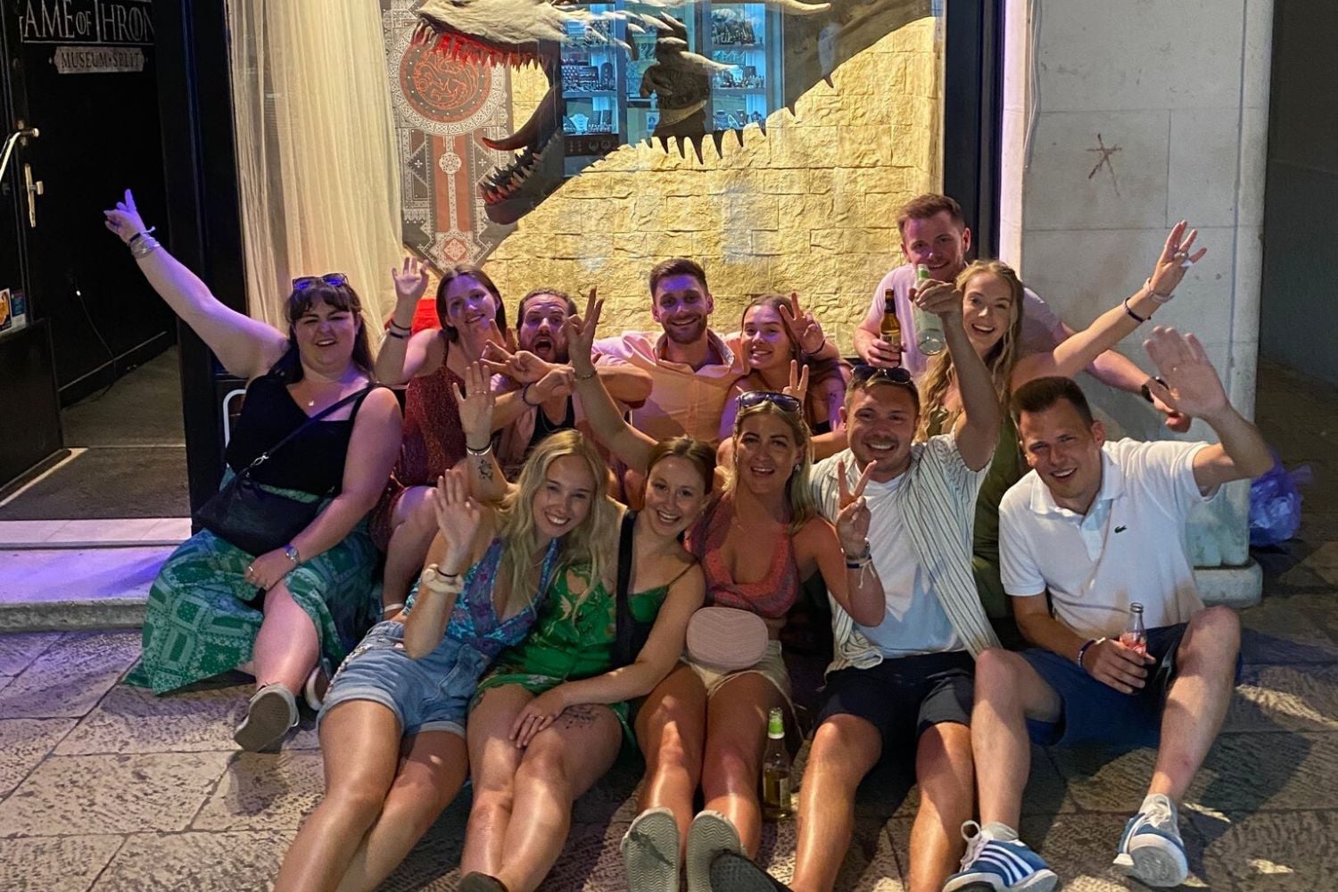 Group of travellers smiling together on a night out in Split, Croatia