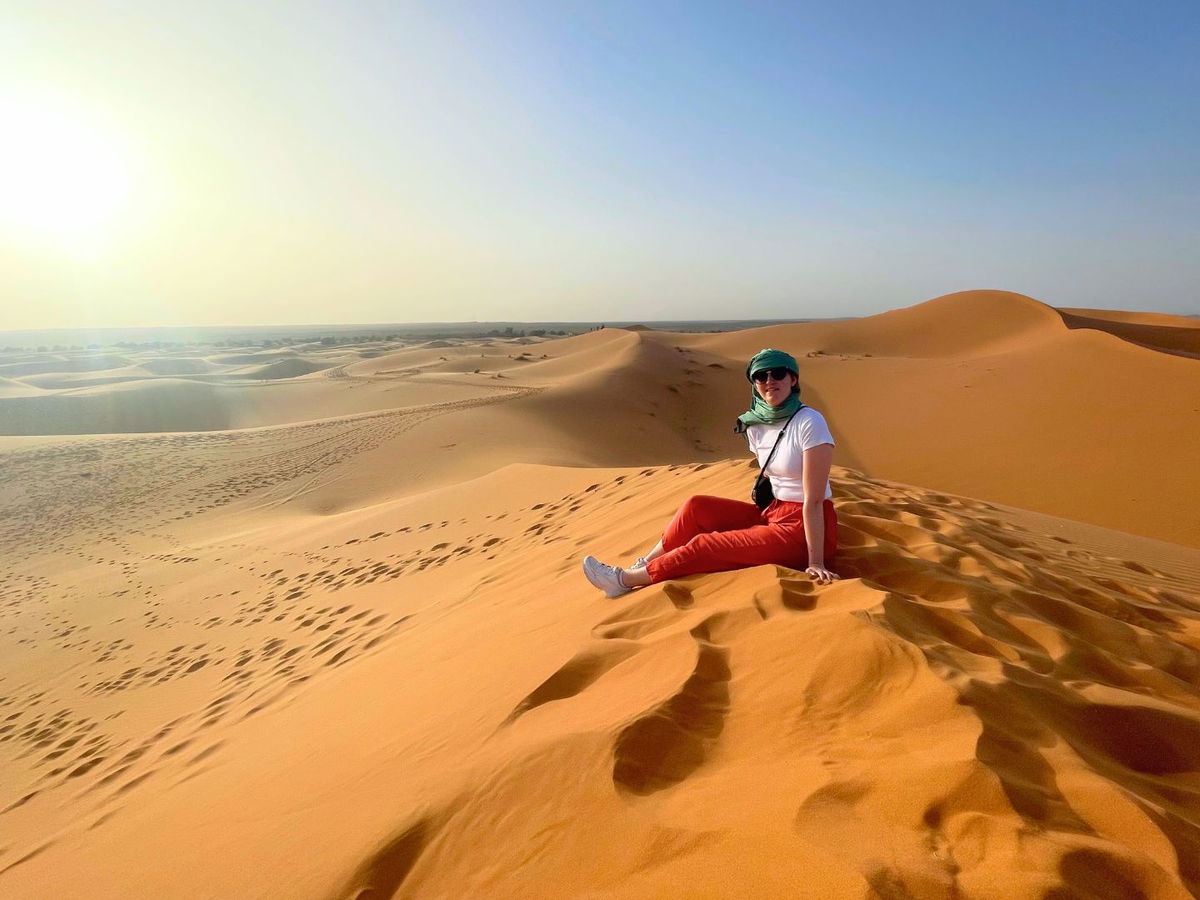 Traveller at on sand dune in the Sahara Desert in Morocco