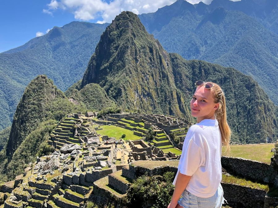 Traveller stood by view of Machu Picchu in Peru