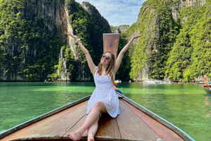 Traveller on a long tail boat in Koh Phi Phi