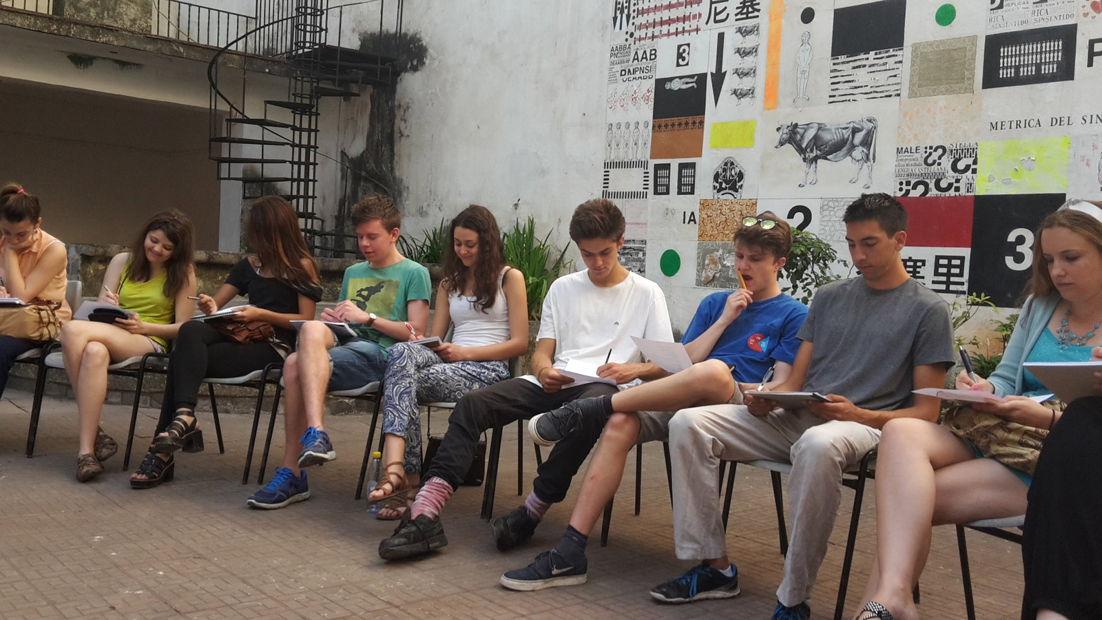 Travellers sitting and writing in notebooks
