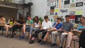 Travellers sitting and writing in notebooks