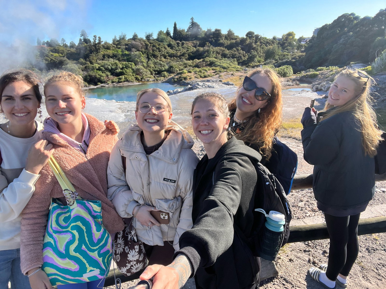 Group in front geyser in Rotorua, New Zealand 