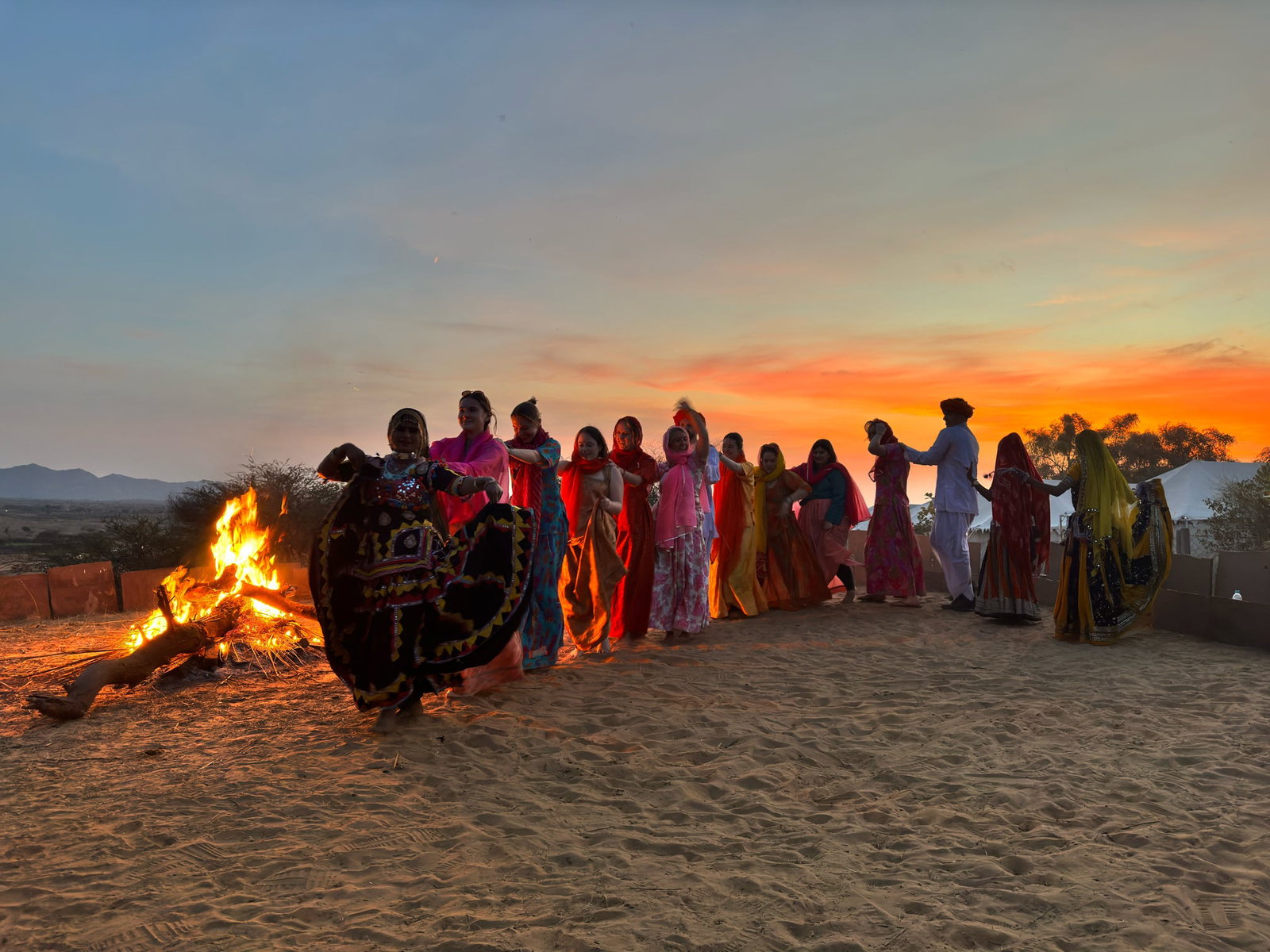 Travellers dancing in India at sunset