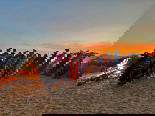 Travellers dancing in India at sunset