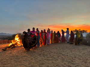 Travellers dancing in India at sunset