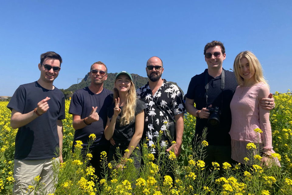 Group of holiday travellers in south korea in field of flowers