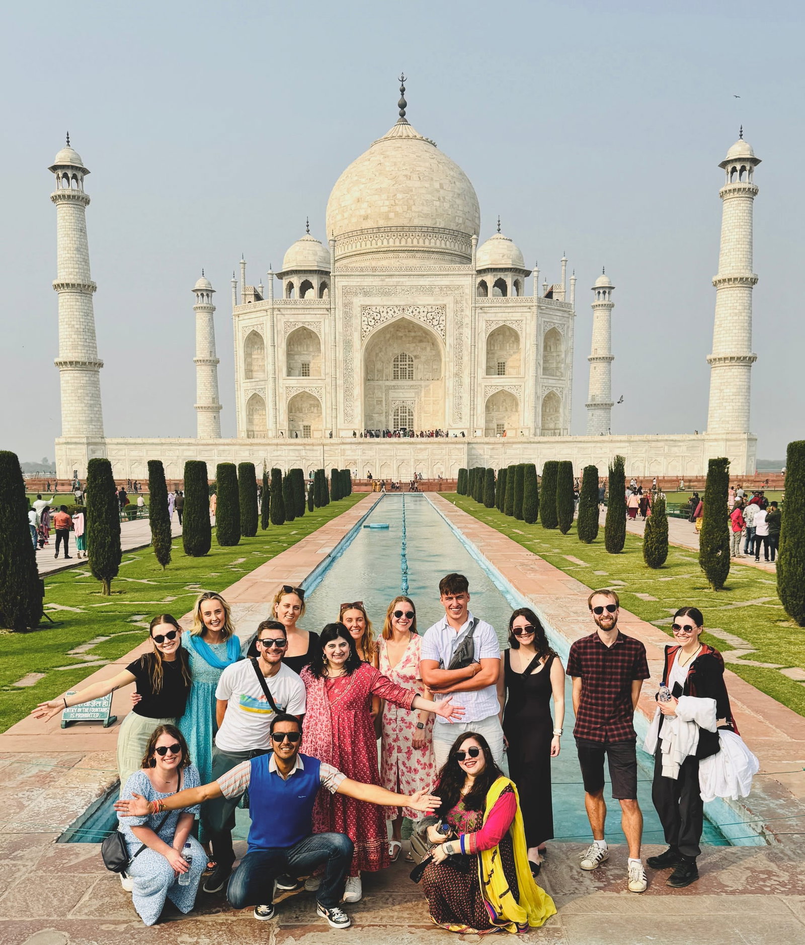 Group of travellers in front of Taj Mahal in India