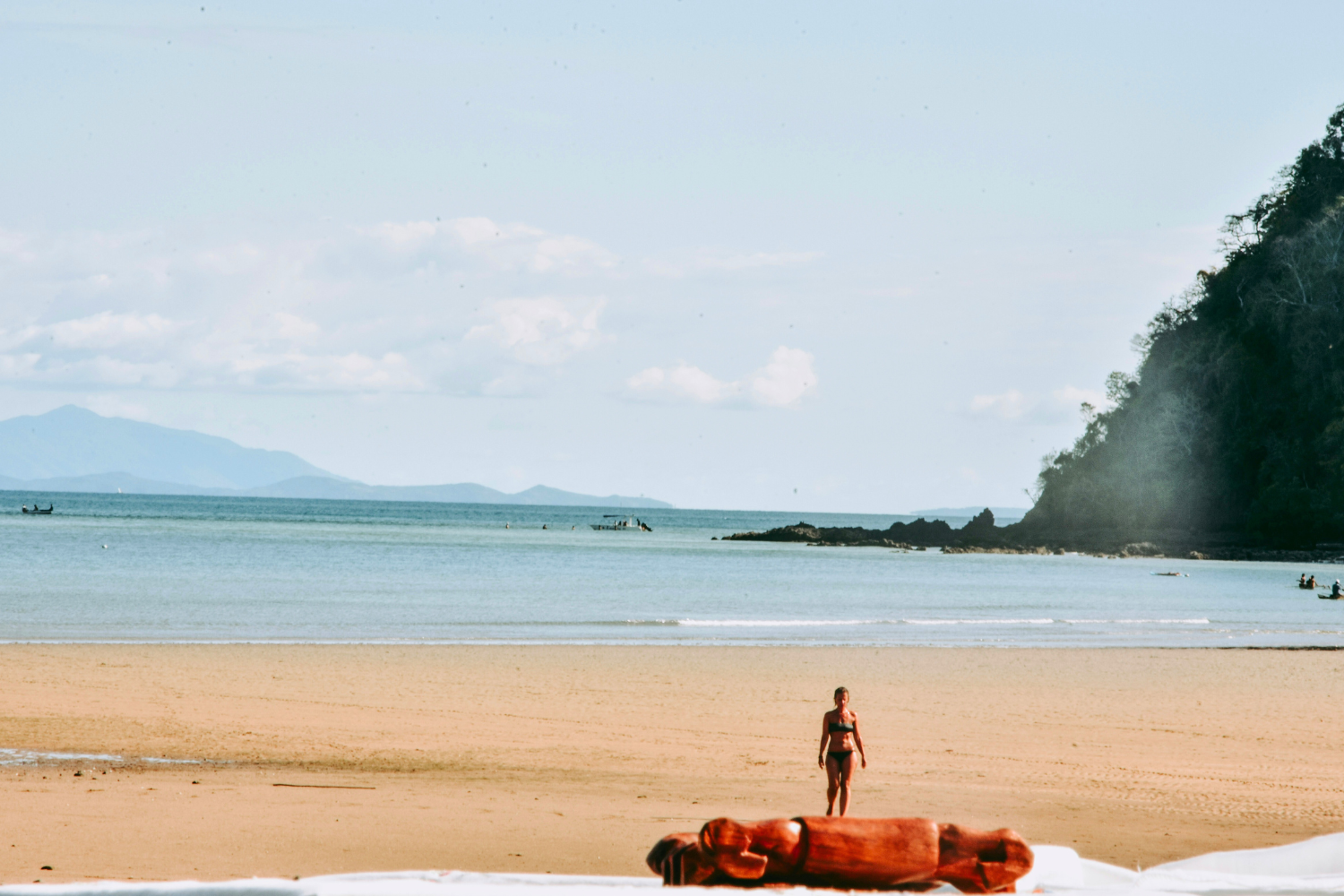 Traveller walking down the beach in Nosy Be with ocean views behind