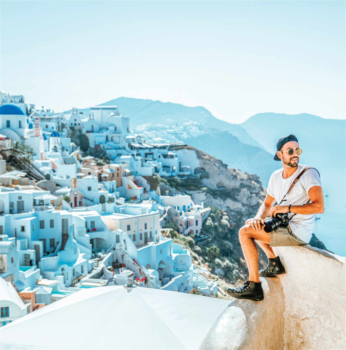 Male Traveller at viewpoint in Santorini, Oia Greece