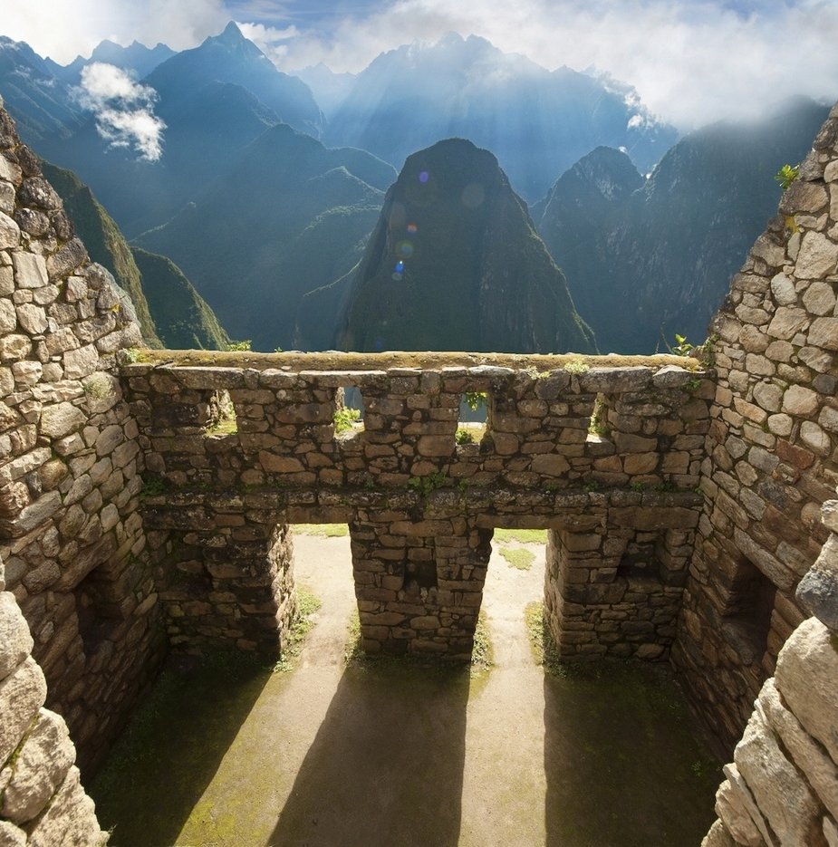 Building at Machu Picchu with clouds in the background