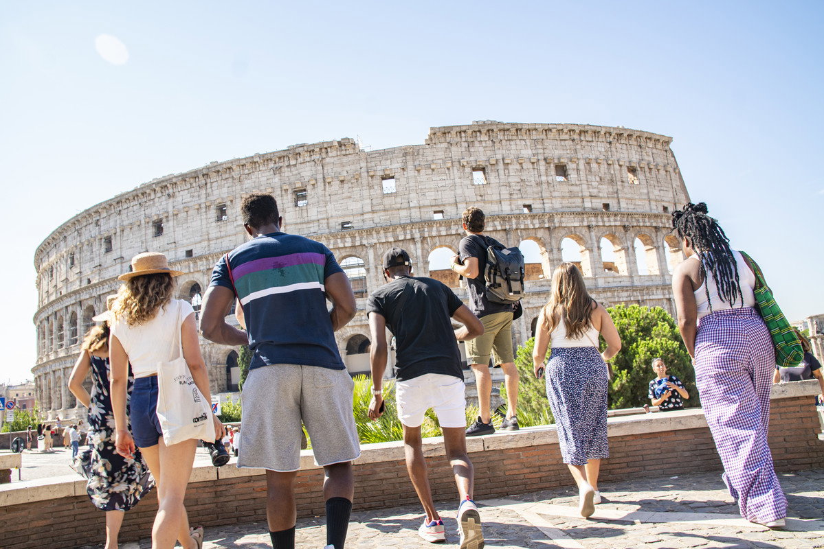 Group travellers at the colosseum in italy rome