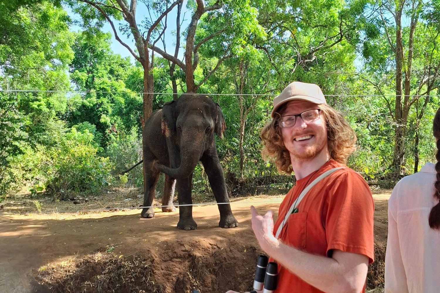 Traveller pointing at an elephant in Sri Lanka