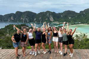 Group of travellers with arms up at Koh Phi Phi viewpoint