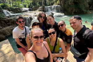 Group of travellers by waterfall in Laos, Southeast Asia