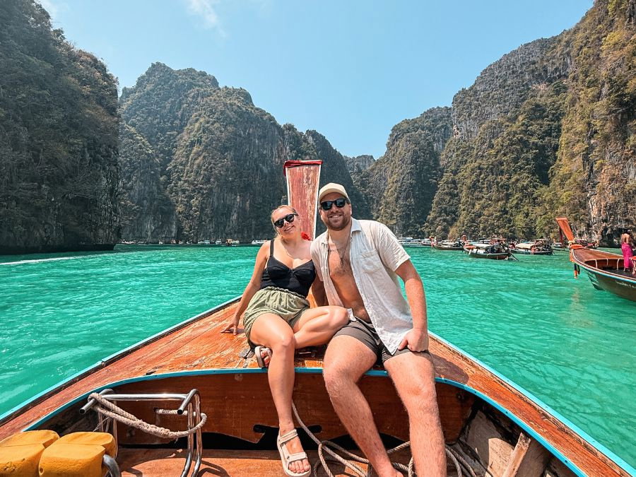 Two travellers on boat in water at Koh Phi Phi