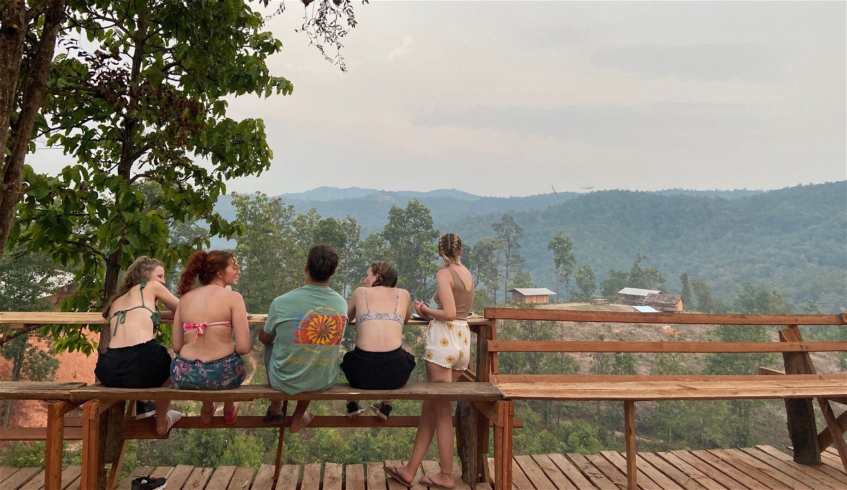 Group of travellers looking out in rural Chiang Mai, Thailand
