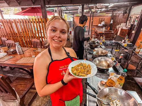 Traveller with plate of Pad Thai on cooking class in Thailand