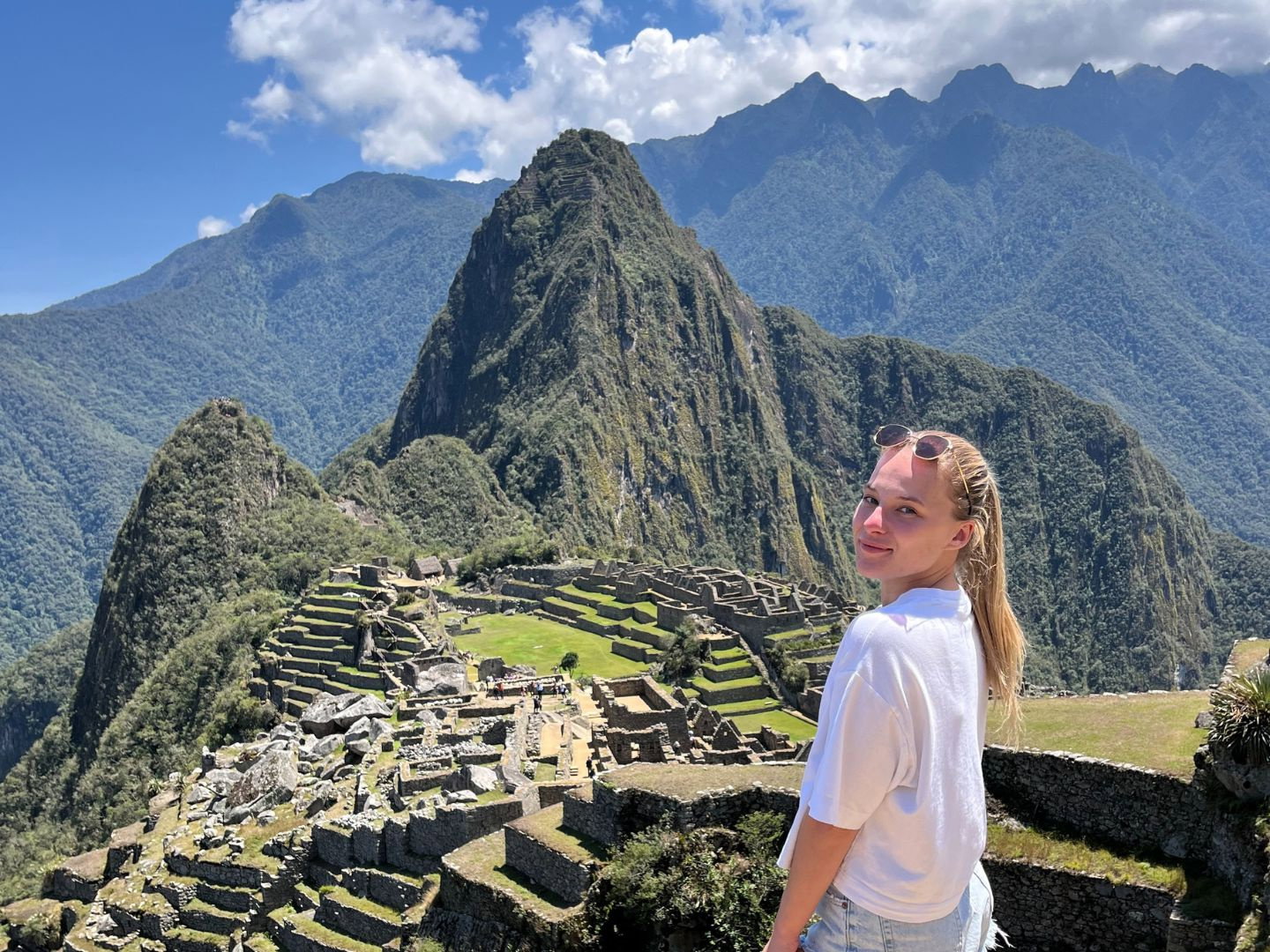 Traveller stood by view of Machu Picchu in Peru