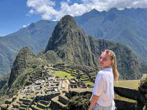 Traveller stood by view of Machu Picchu in Peru