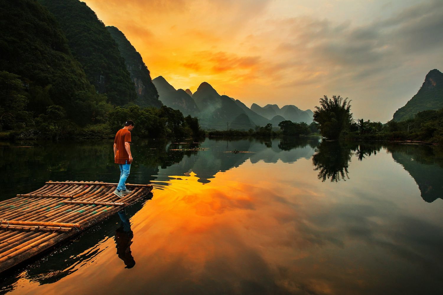 Traveller looking out across Yangshuo at sunset