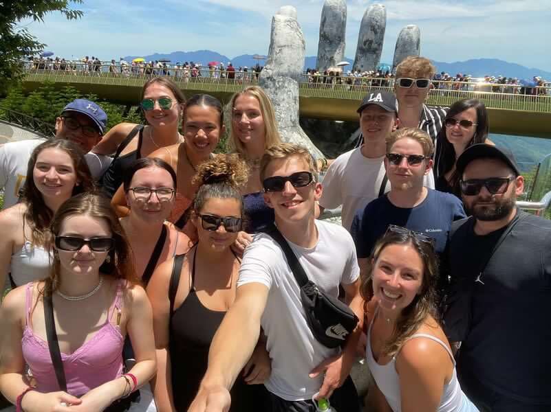 Group of travellers on da nang vietnam golden hand bridge