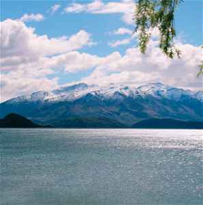 A pristine lake below snow-capped mountain in Wanaka, New Zealand