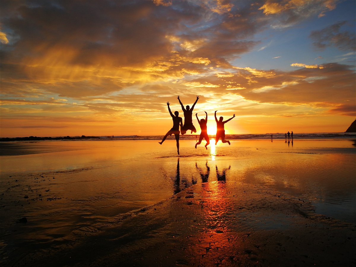 Group jumping at sunset on the beach in Costa Rica 