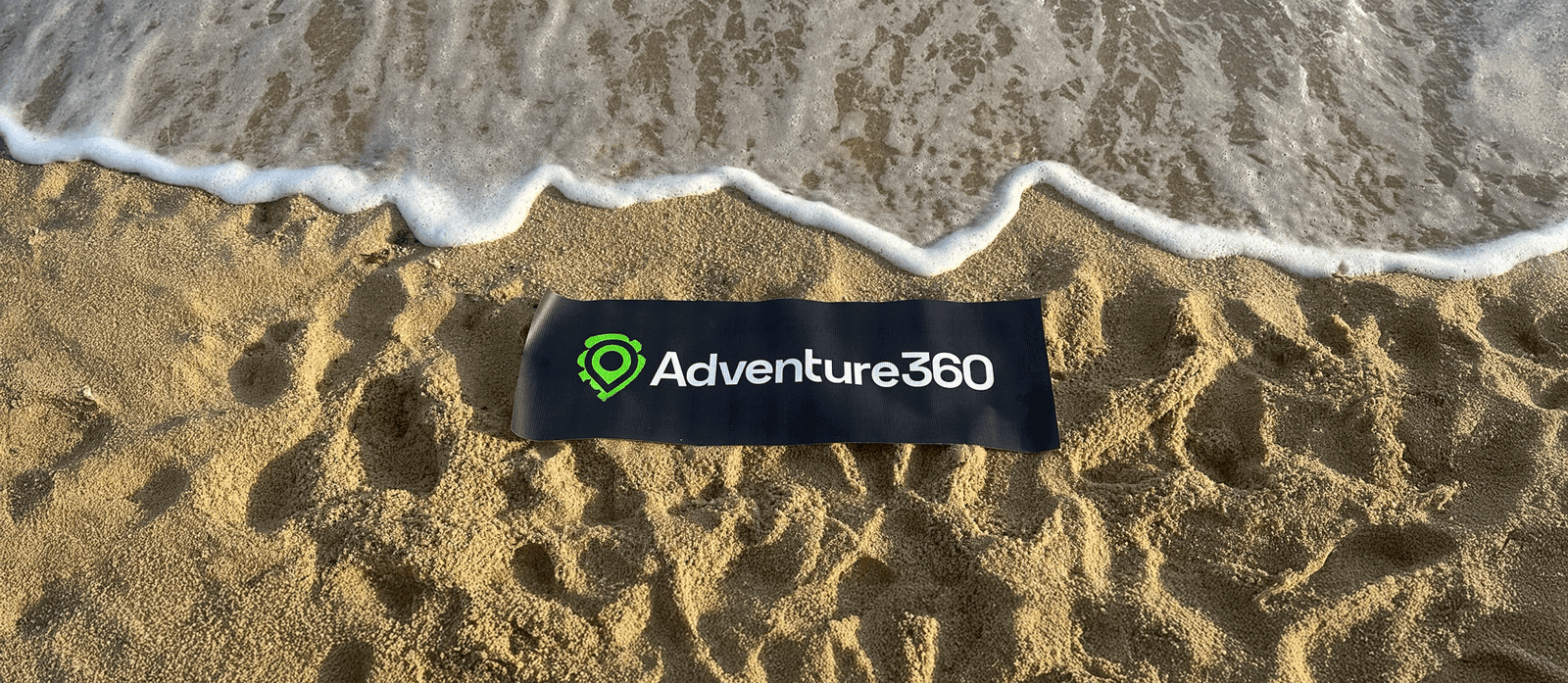Adventure360 logo in the sand on beach in Thailand Asia