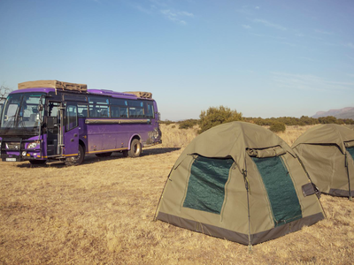 Tents next to lando vehicle in Africa national park
