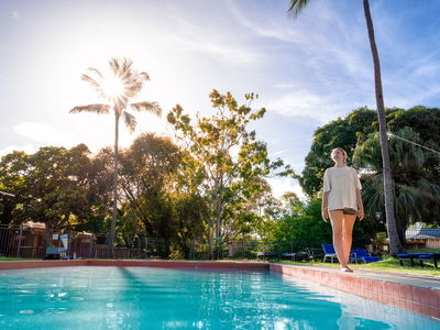 Woman walking near pool at airlie beach accommodation