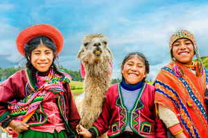 Smiling Peruvian children with llama