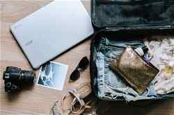 Packing a suitcase with laptop and camera