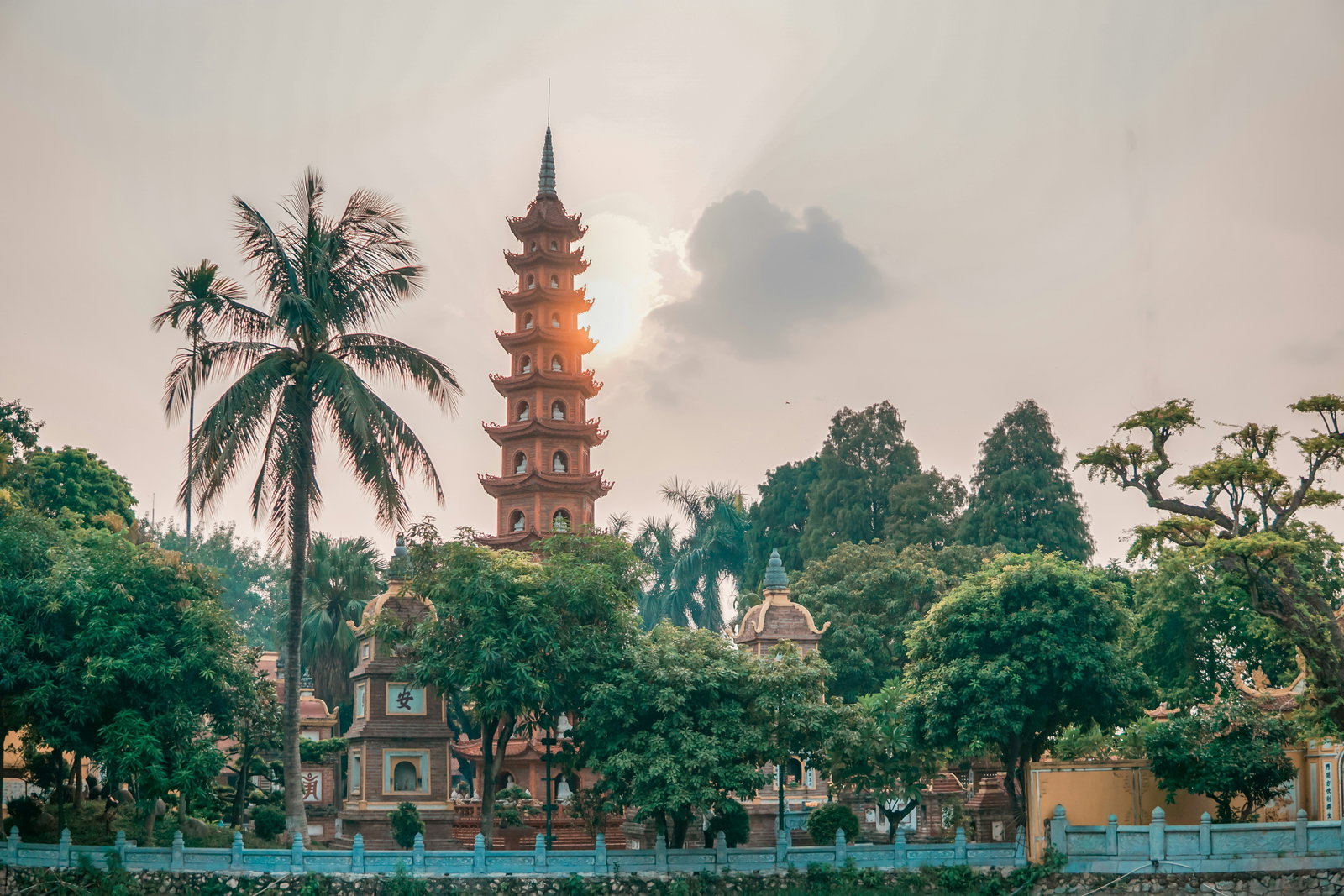 Pagoda and surrounding structures on a tree lined street in Hanoi's Old Quarter