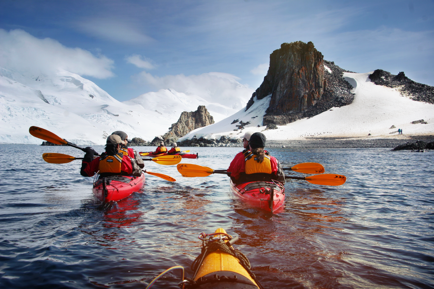 Group of young travellers on kayaks in Antarctica