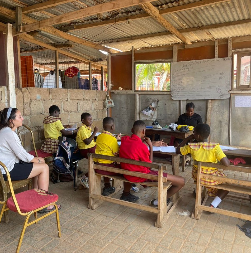 Volunteer teachers in classroom teaching students in ghana