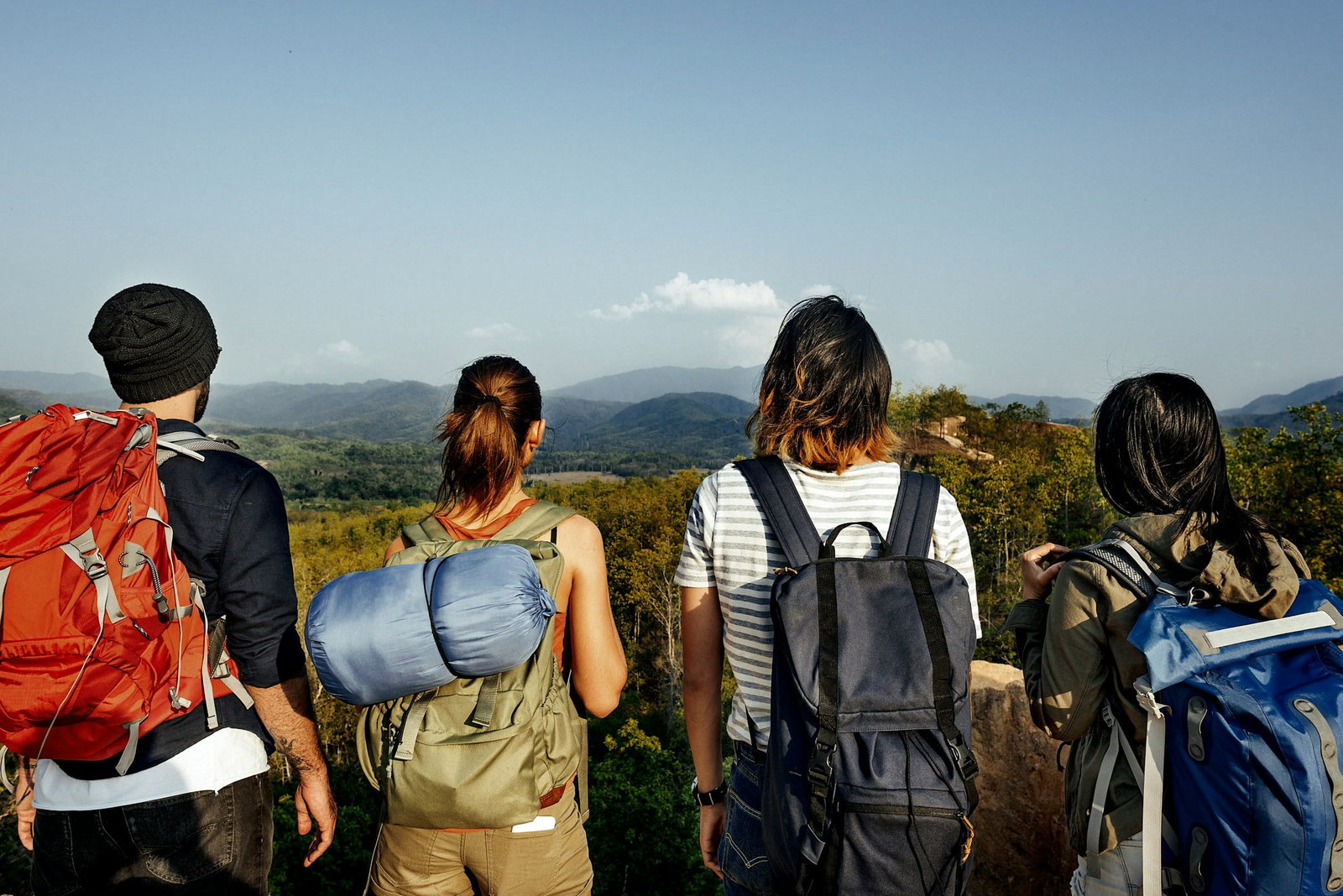 A group of backpackers looking at mountains in the distance