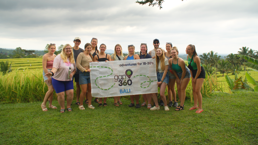 Group holding Gap 360 Bali flag in Bali