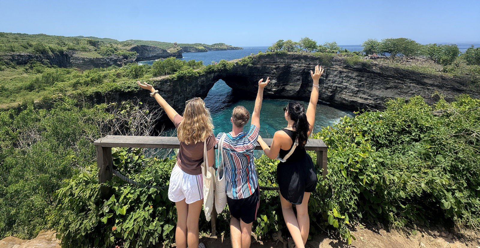 Group travellers looking over Nusa Penida in Bali Indonesia