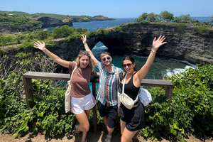 Travellers with arms at the air at Broken Beach on Nusa Penida in Bali