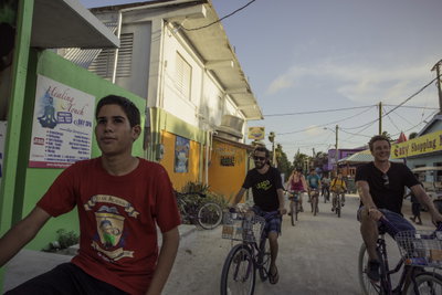 Travellers cycling down a street in Belize