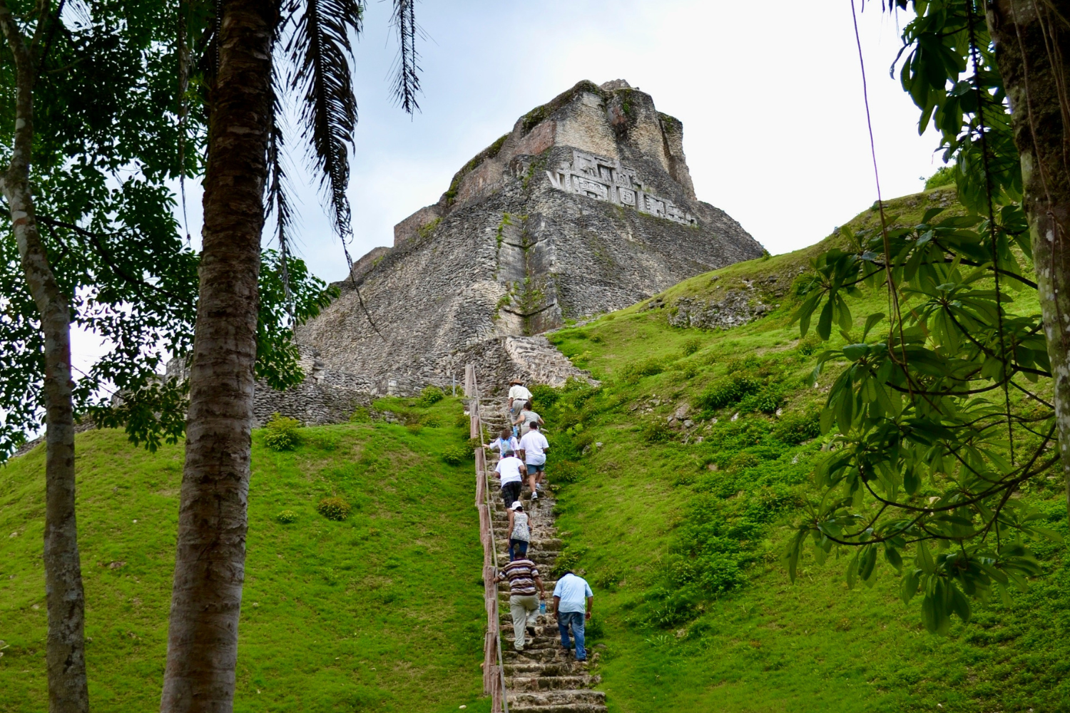 Travellers exploring ancient mayan site, xunantunich, in Belize